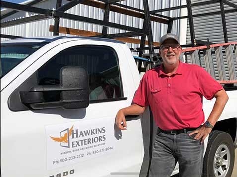 Owner posing for a photo with the company vehicle